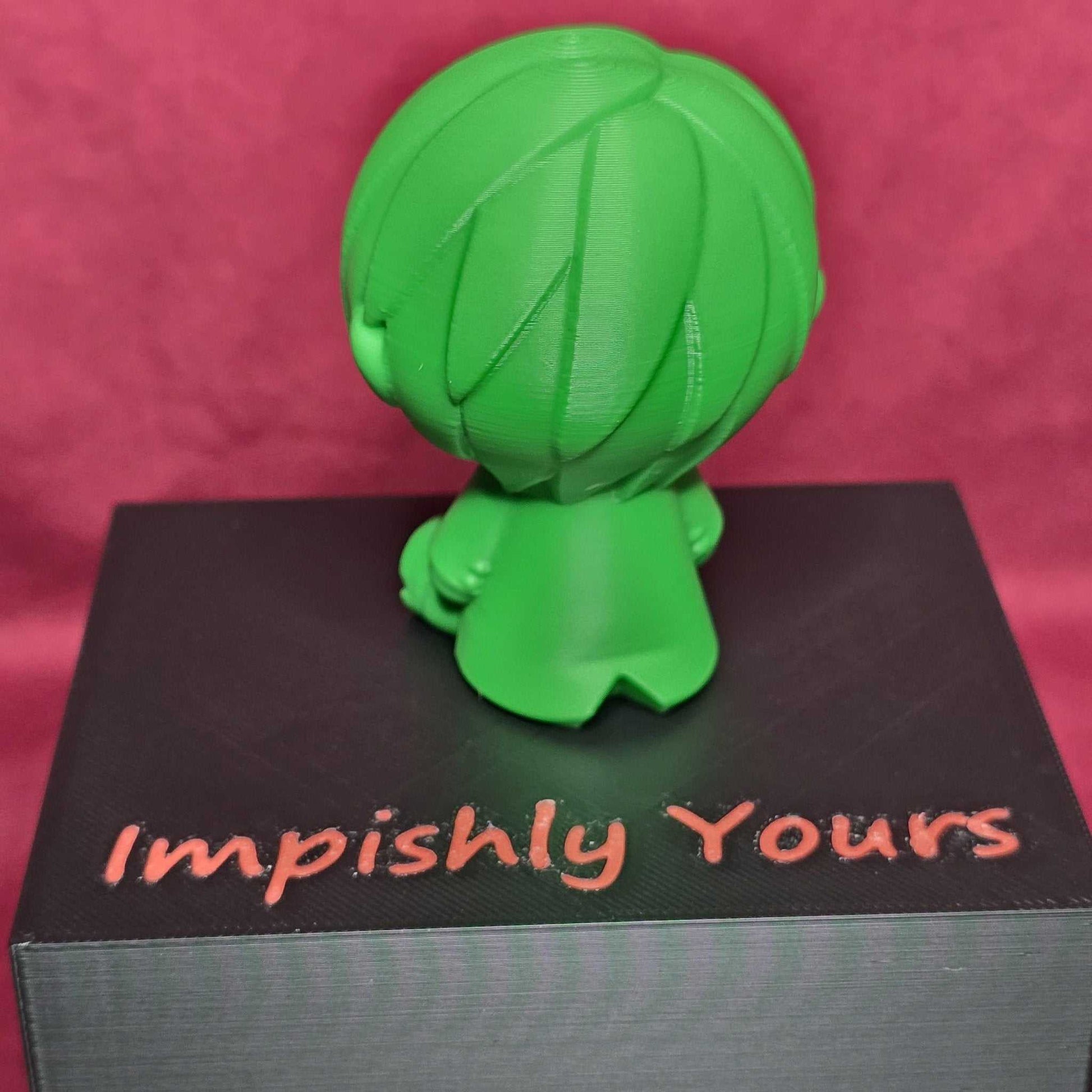 Rear view of Chibi Sanji Figure - 3D One Piece Collectible in green PLA plastic, showing hair and coat details on 'Impishly Yours' box.
